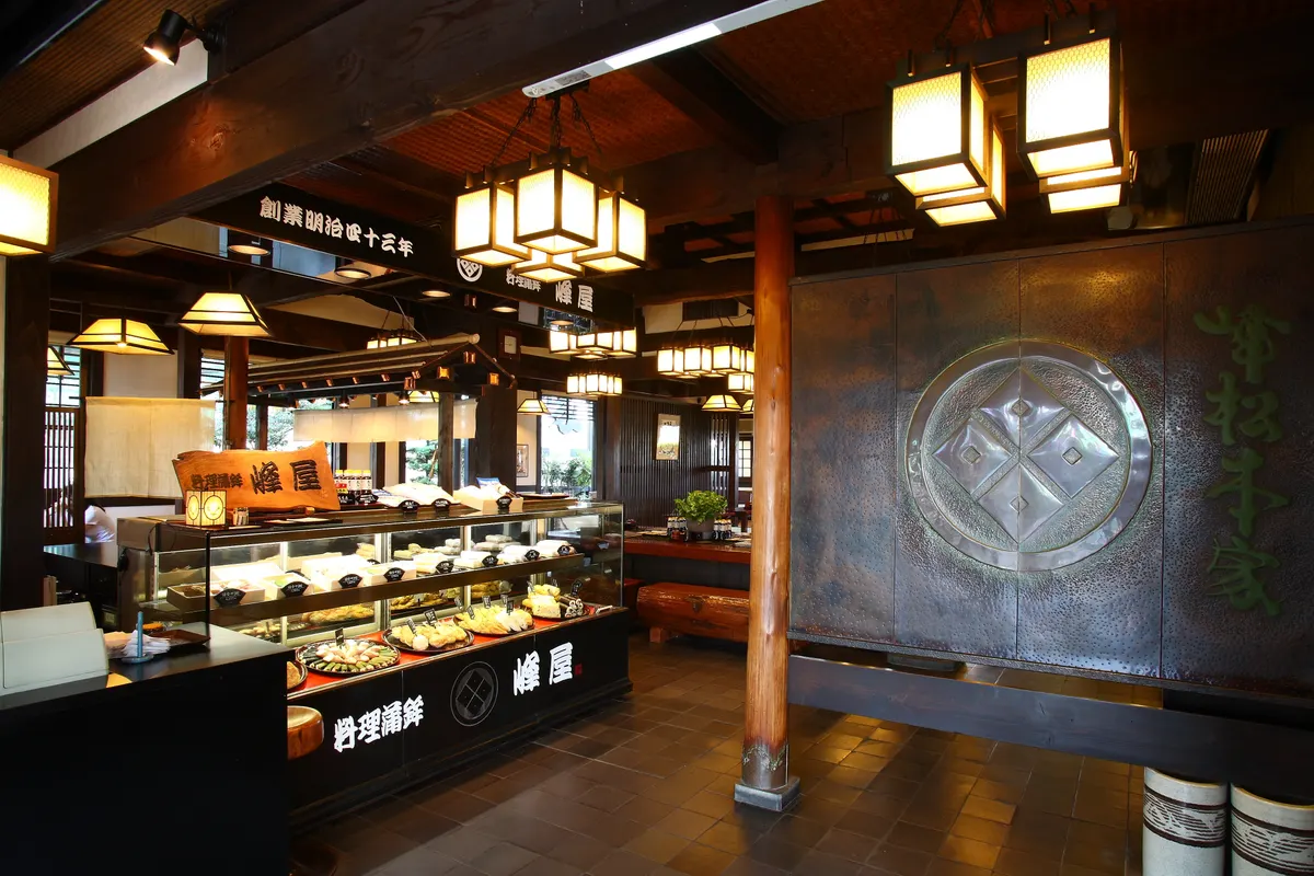 家紋を掲げた店内の入口と、蒲鉾のショーケース